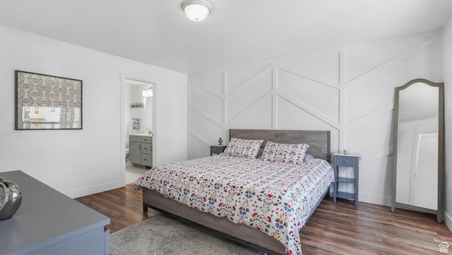 5241 W S Jordan Pkwy, South Jordan, UT 84009 - bedroom with wood finished floors, baseboards, a decorative wall, and ensuite bath
