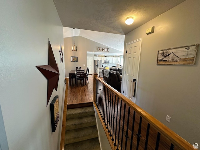 8675 S Pebblecreek Rd, West Jordan, UT 84081 - staircase featuring wood finished floors, vaulted ceiling, and baseboards
