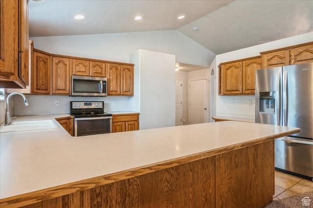 432 S 755 E, Layton, UT 84041 - kitchen with appliances with stainless steel finishes, a sink, vaulted ceiling, light countertops, and brown cabinets