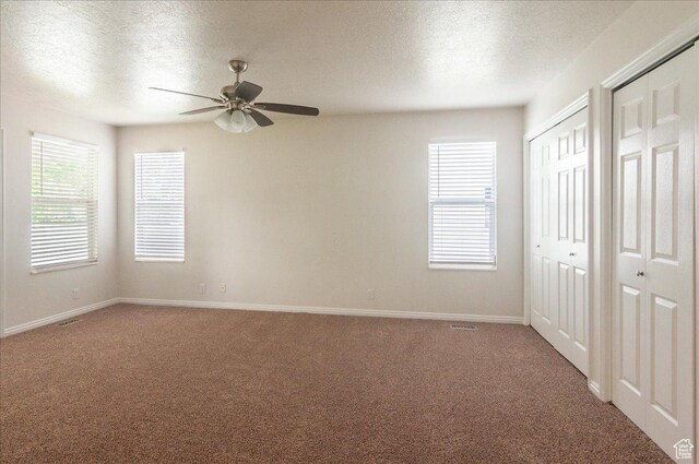 432 S 755 E, Layton, UT 84041 - unfurnished bedroom featuring multiple closets, light carpet, a textured ceiling, baseboards, and a ceiling fan