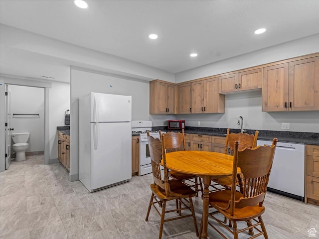 223 E 200 N, Ephraim, UT 84627 - kitchen with white appliances, dark countertops, recessed lighting, and brown cabinets