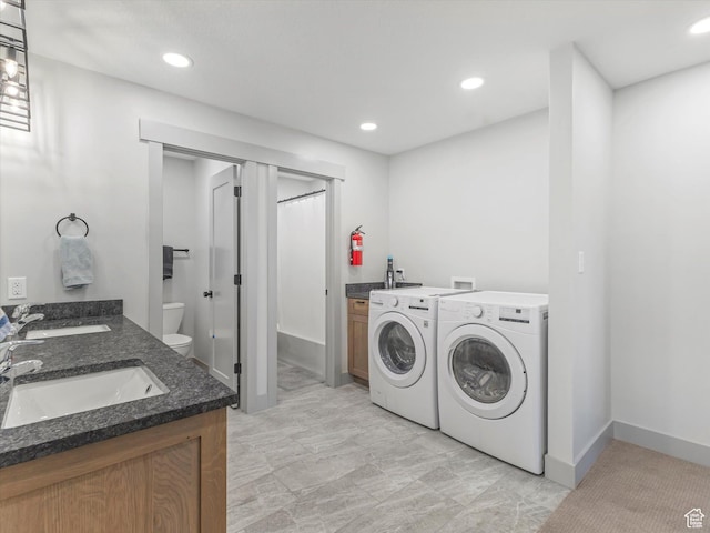 223 E 200 N, Ephraim, UT 84627 - washroom featuring washing machine and dryer, a sink, baseboards, and recessed lighting