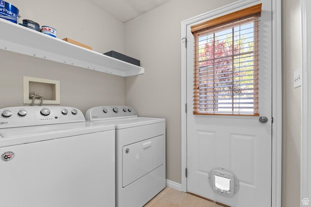 878 Independence Ave, Provo, UT 84604 - laundry room featuring washer and dryer, plenty of natural light, light tile patterned flooring, and baseboards