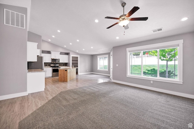 818 S 560 E, Providence, UT 84332 - unfurnished living room with recessed lighting, baseboards, ceiling fan, light wood-style floors, and lofted ceiling