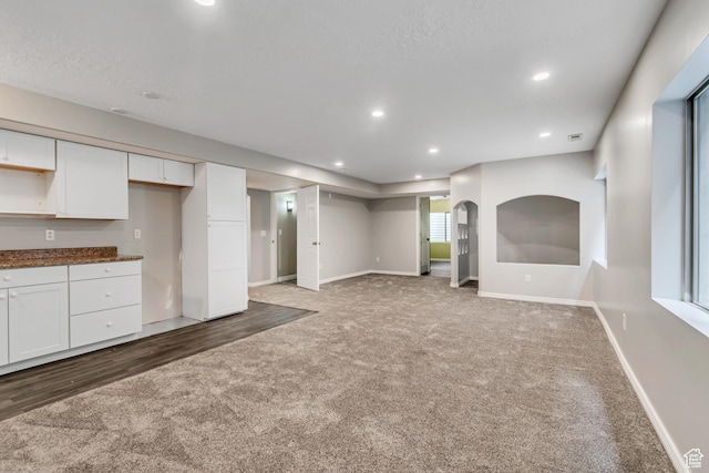 10972 S Crystal View Way S, Jordan, UT 84095 - unfurnished living room with carpet flooring, baseboards, recessed lighting, and arched walkways