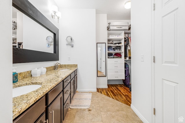 839 W Jordan Oaks Ct S, Sandy, UT 84070 - bathroom with double vanity, baseboards, and a walk in closet