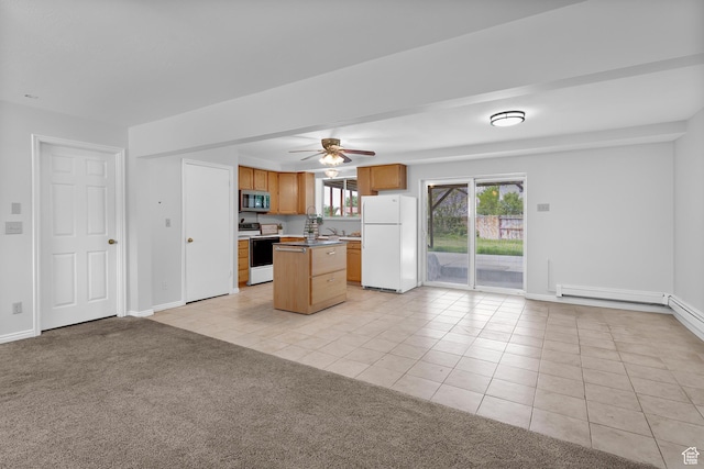 1173 N 350 W, Centerville, UT 84014 - kitchen featuring white appliances, light tile patterned floors, open floor plan, a kitchen island, and baseboards