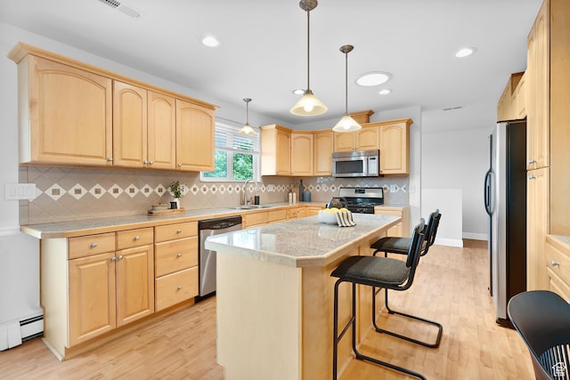 1173 N 350 W, Centerville, UT 84014 - kitchen featuring stainless steel appliances, light brown cabinets, a sink, light wood-type flooring, and recessed lighting