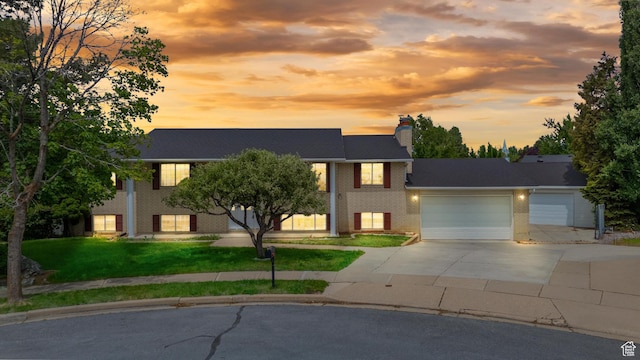 1173 N 350 W, Centerville, UT 84014 - view of front of home with driveway, a garage, brick siding, a chimney, and a front lawn