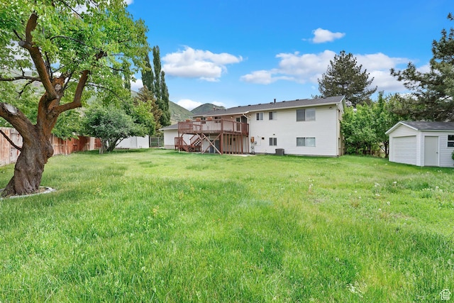 1173 N 350 W, Centerville, UT 84014 - rear view of property with a deck, an outbuilding, stairway, and a garage
