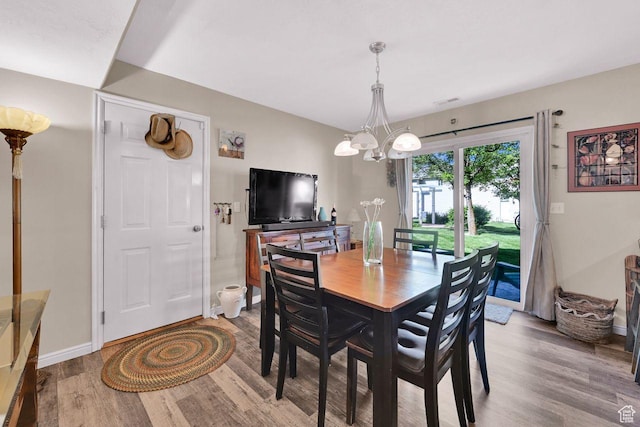 1427 S Blossom Ln, Ogden, UT 84404 - dining area featuring a chandelier, wood finished floors, and baseboards