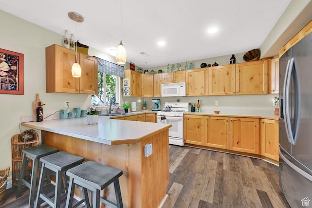 1427 S Blossom Ln, Ogden, UT 84404 - kitchen with white appliances, a peninsula, a sink, dark wood-type flooring, and light countertops