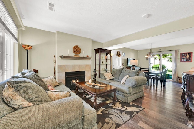 1427 S Blossom Ln, Ogden, UT 84404 - living area with a tiled fireplace and wood finished floors