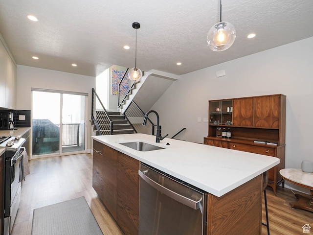 423 E 2100 S Unit 204, Salt Lake City, UT 84115 - kitchen featuring a sink, stainless steel dishwasher, gas stove, light wood-style floors, and a textured ceiling