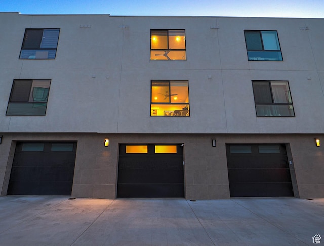 423 E 2100 S Unit 204, Salt Lake City, UT 84115 - view of building exterior featuring an attached garage and driveway