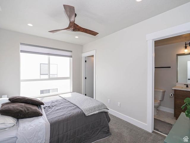 423 E 2100 S Unit 204, Salt Lake City, UT 84115 - bedroom with dark carpet, recessed lighting, baseboards, connected bathroom, and ceiling fan