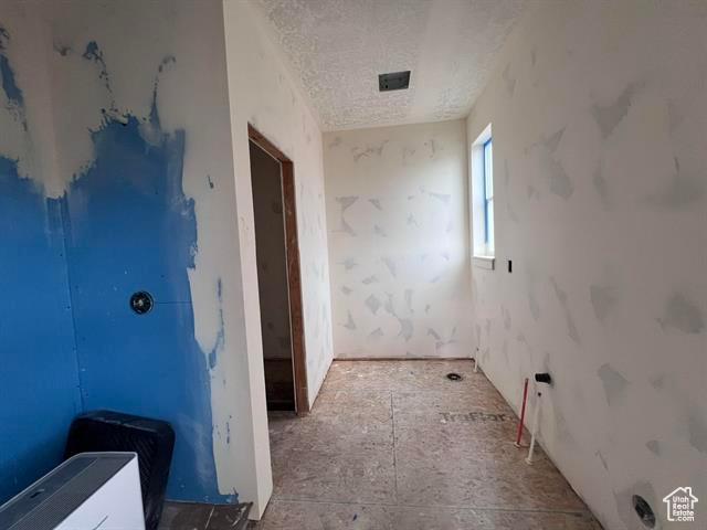 1409 Geer, Mccammon, ID 83250 - corridor featuring a textured ceiling