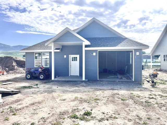 1409 Geer, Mccammon, ID 83250 - view of front of house featuring a mountain view, roof with shingles, and an attached garage