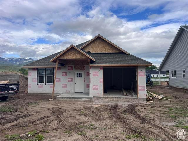 1409 Geer, Mccammon, ID 83250 - unfinished property featuring an attached garage and a shingled roof