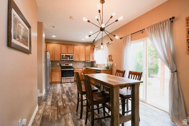 6466 W 8375 S, West Jordan, UT 84081 - dining space with a chandelier, dark wood-type flooring, recessed lighting, and baseboards