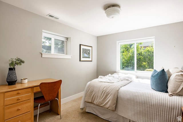 2262 E 1700 S, Salt Lake City, UT 84108 - bedroom with light carpet, multiple windows, a desk, and baseboards