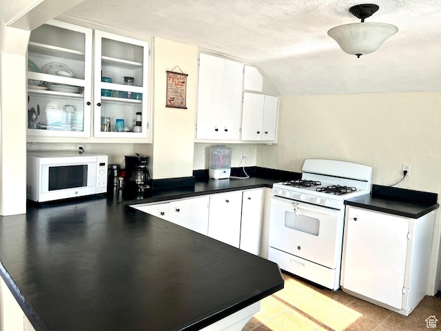 145 N 200 W, Roosevelt, UT 84066 - kitchen with white appliances, dark countertops, white cabinets, glass insert cabinets, and vaulted ceiling