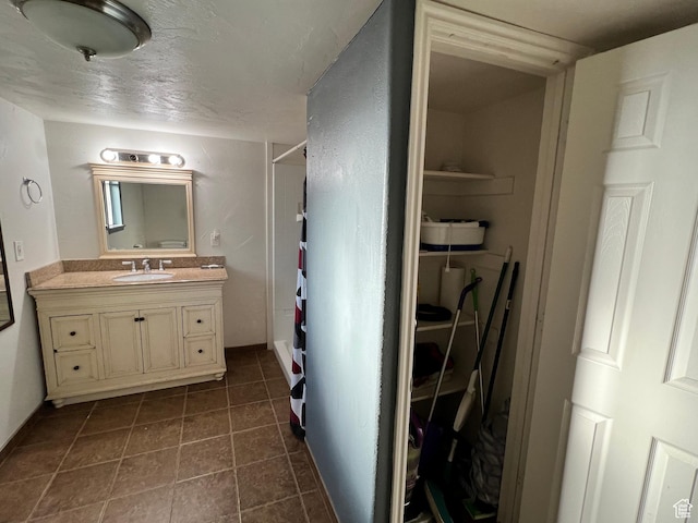 145 N 200 W, Roosevelt, UT 84066 - full bathroom with vanity, a shower, tile patterned flooring, a closet, and a textured ceiling