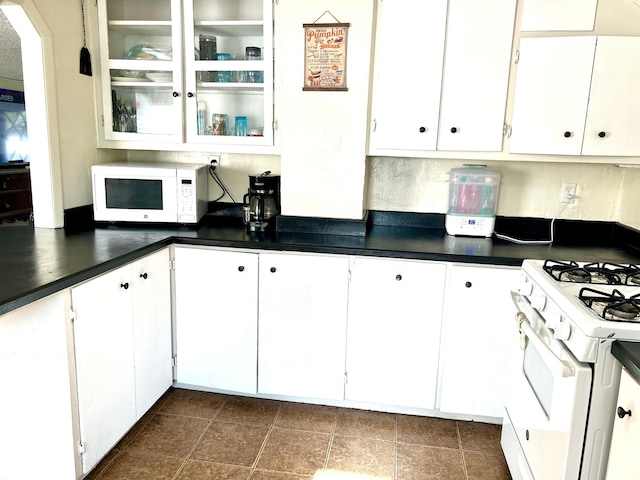 145 N 200 W, Roosevelt, UT 84066 - kitchen with white appliances, dark countertops, and white cabinetry