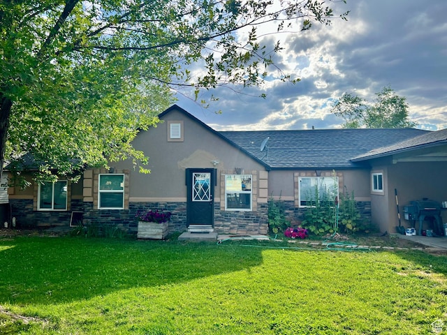 145 N 200 W, Roosevelt, UT 84066 - view of front of house with stone siding, a front lawn, stucco siding, and a shingled roof