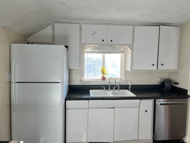 145 N 200 W, Roosevelt, UT 84066 - kitchen featuring freestanding refrigerator, dishwasher, dark countertops, white cabinetry, and lofted ceiling