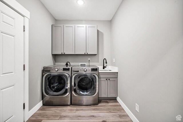 670 N Lake Sight Dr, Garden City, UT 84028 - laundry area with cabinet space, independent washer and dryer, baseboards, light wood-type flooring, and recessed lighting