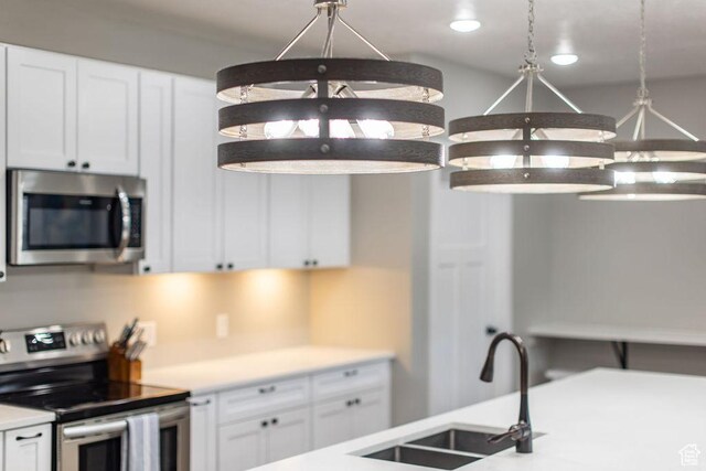 670 N Lake Sight Dr, Garden City, UT 84028 - kitchen featuring stainless steel appliances, white cabinetry, and light countertops
