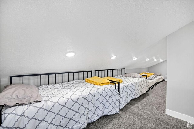 670 N Lake Sight Dr, Garden City, UT 84028 - carpeted bedroom featuring lofted ceiling and baseboards