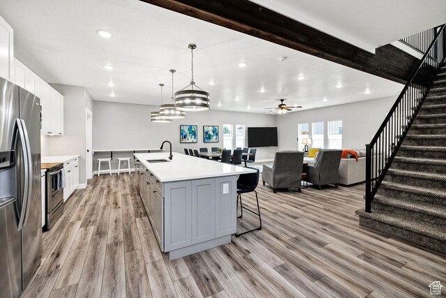 670 N Lake Sight Dr, Garden City, UT 84028 - kitchen with a sink, appliances with stainless steel finishes, light countertops, light wood-type flooring, and gray cabinets