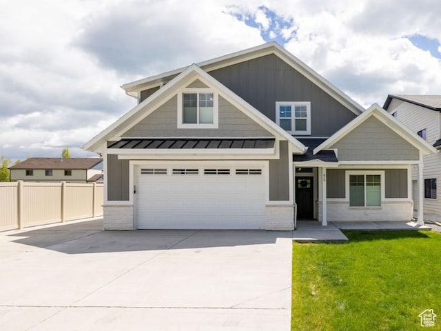 670 N Lake Sight Dr, Garden City, UT 84028 - craftsman-style home featuring board and batten siding, driveway, a standing seam roof, an attached garage, and metal roof