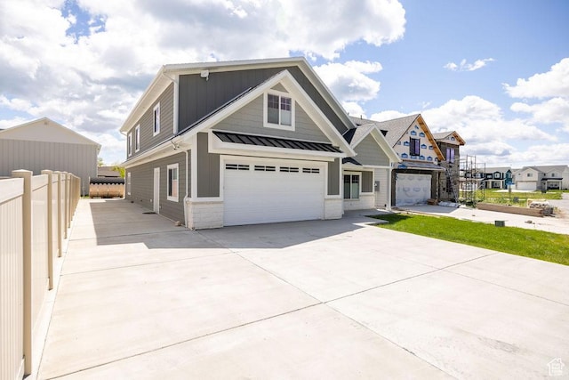 670 N Lake Sight Dr, Garden City, UT 84028 - view of front of property featuring an attached garage, concrete driveway, a standing seam roof, metal roof, and board and batten siding