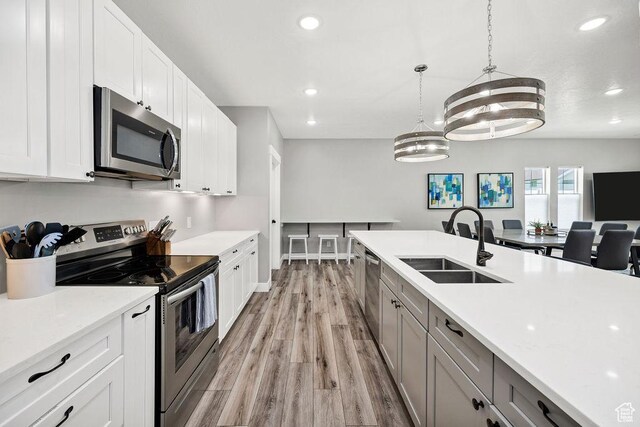670 N Lake Sight Dr, Garden City, UT 84028 - kitchen featuring stainless steel appliances, a sink, recessed lighting, light countertops, and light wood-style flooring
