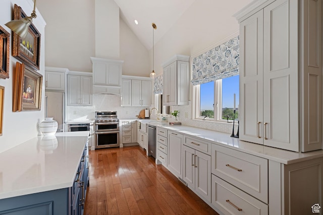 281 N Almond St W, Salt Lake City, UT 84103 - kitchen featuring stainless steel appliances, backsplash, light countertops, hardwood / wood-style floors, and hanging light fixtures