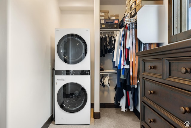 1765 E Kings Peak Cir Unit Cp-21, Heber City, UT 84032 - washroom featuring stacked washer and clothes dryer, light colored carpet, and baseboards