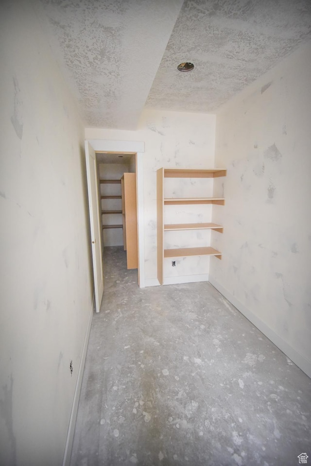 76 W 200 S, Hyde Park, UT 84318 - empty room featuring unfinished concrete floors, baseboards, and a textured ceiling