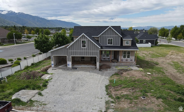 76 W 200 S, Hyde Park, UT 84318 - view of front of property featuring covered porch, board and batten siding, a mountain view, driveway, and roof with shingles