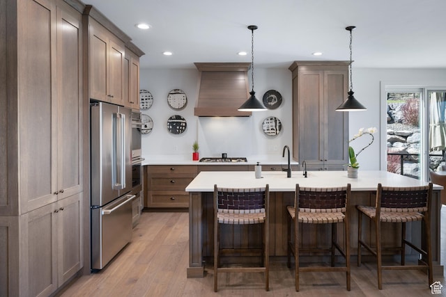 13200 N Alexis Dr, Heber City, UT 84032 - kitchen with appliances with stainless steel finishes, a sink, premium range hood, recessed lighting, and light countertops