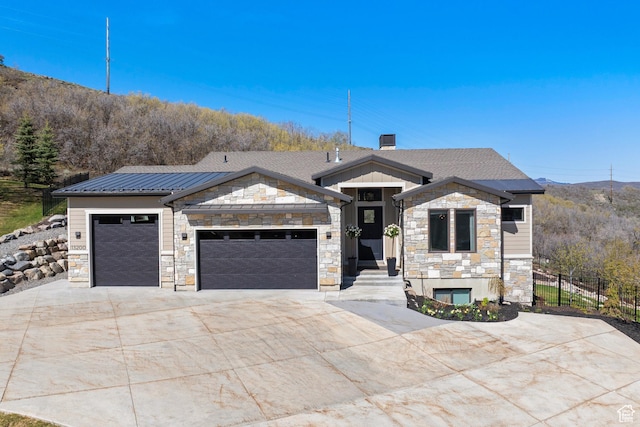 13200 N Alexis Dr, Heber City, UT 84032 - view of front of home with stone siding, concrete driveway, an attached garage, metal roof, and a standing seam roof