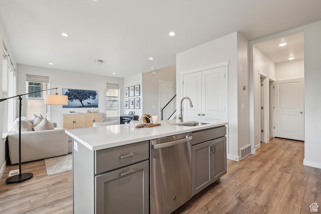 5991 Westridge Rd, Heber City, UT 84032 - kitchen featuring stainless steel dishwasher, gray cabinetry, a sink, light wood-type flooring, and light countertops
