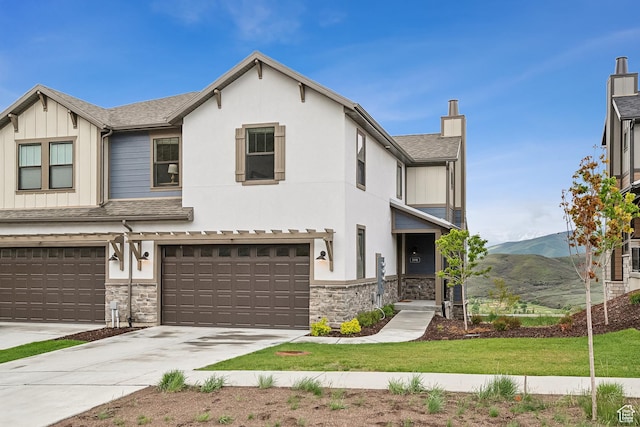 5991 Westridge Rd, Heber City, UT 84032 - view of property with a mountain view, stone siding, an attached garage, board and batten siding, and roof with shingles