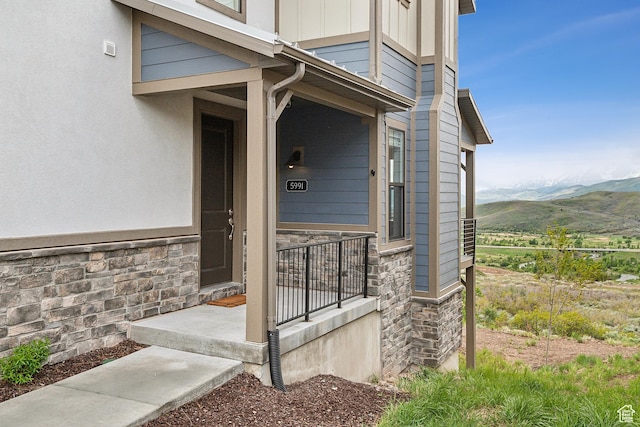 5991 Westridge Rd, Heber City, UT 84032 - entrance to property with stone siding, a mountain view, and a porch