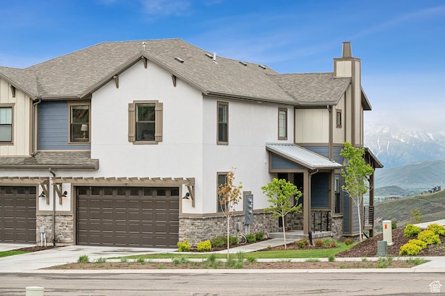 5991 Westridge Rd, Heber City, UT 84032 - view of front of property featuring stone siding, a mountain view, a chimney, and a garage