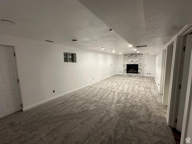 3081 N 100 E, North Ogden, UT 84414 - unfurnished living room featuring carpet, baseboards, a textured ceiling, and a fireplace