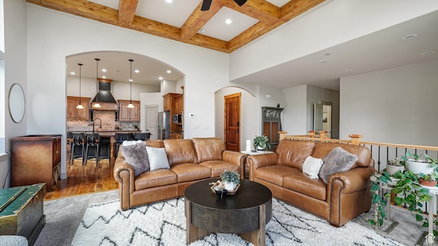 740 S Oak Dr, Woodland Hills, UT 84653 - living area featuring arched walkways, a high ceiling, coffered ceiling, beamed ceiling, and light wood finished floors