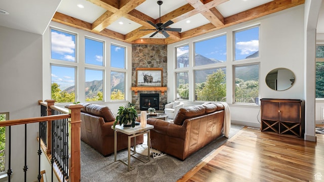 740 S Oak Dr, Woodland Hills, UT 84653 - living room with wood finished floors, a towering ceiling, ceiling fan, beamed ceiling, and a stone fireplace